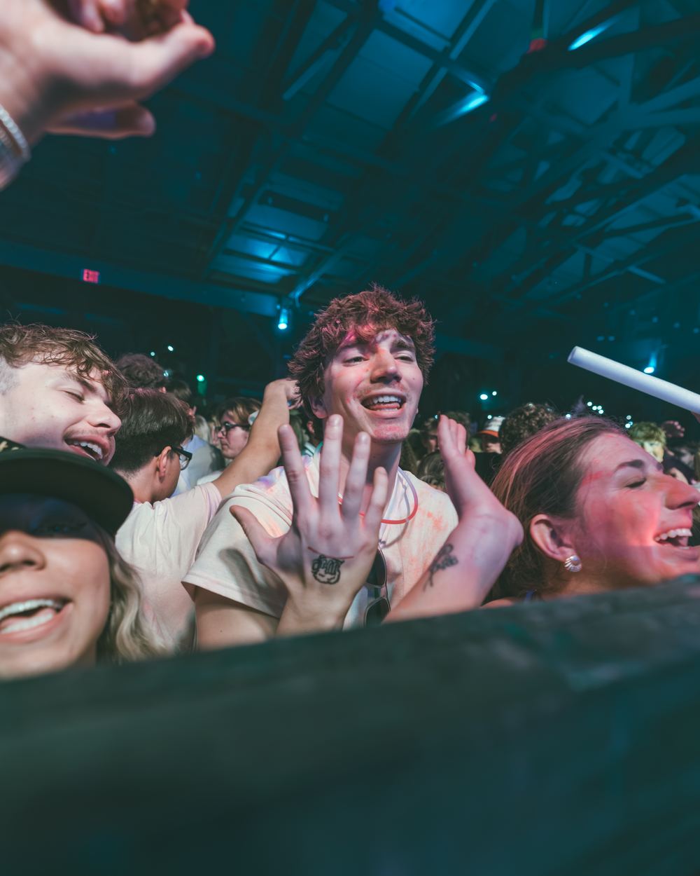 Friends laughing together at the front rail of a spring break party in Panama City Beach