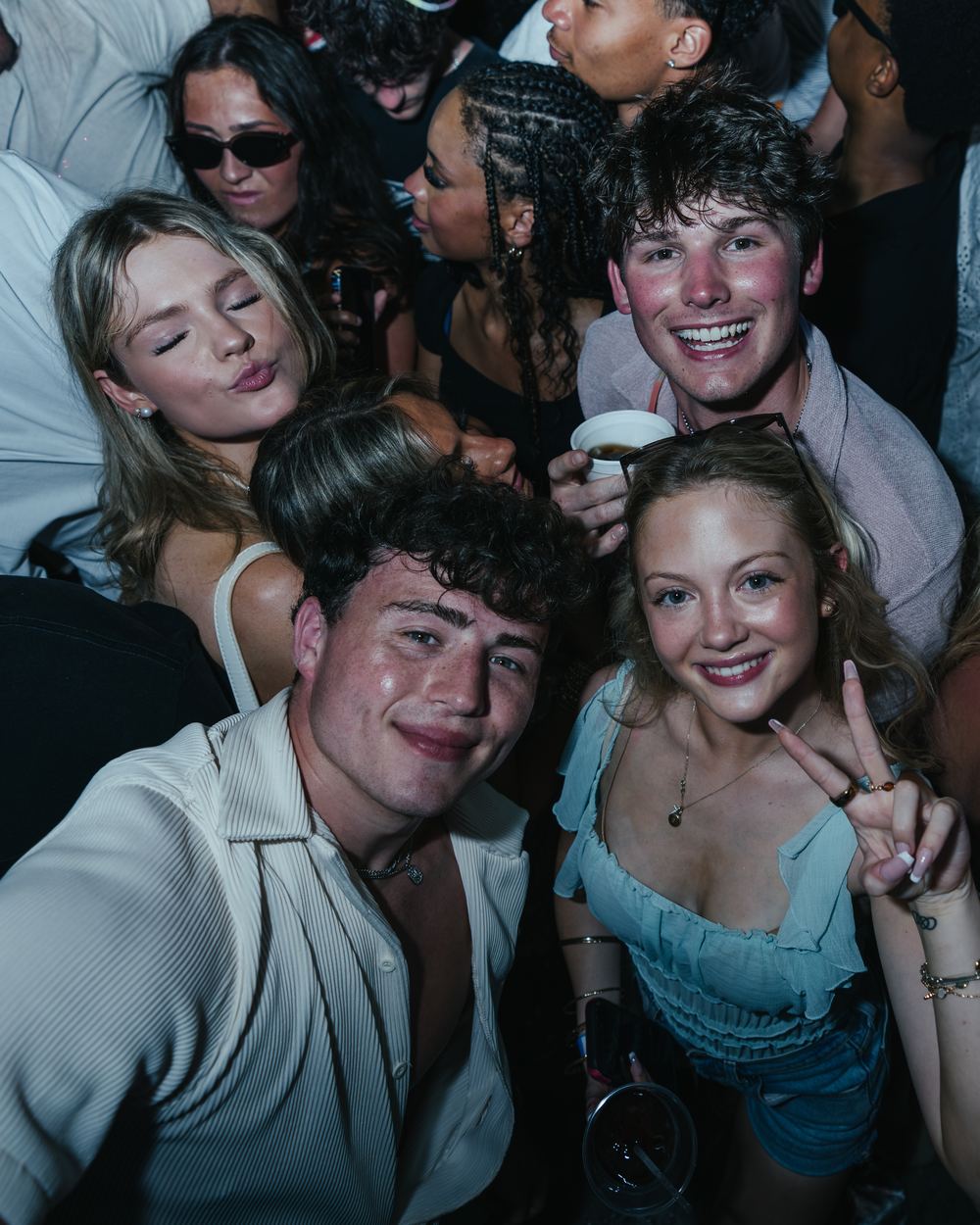 Friends squeezed into a close-up group photo in the crowd at a Panama City Beach spring break party