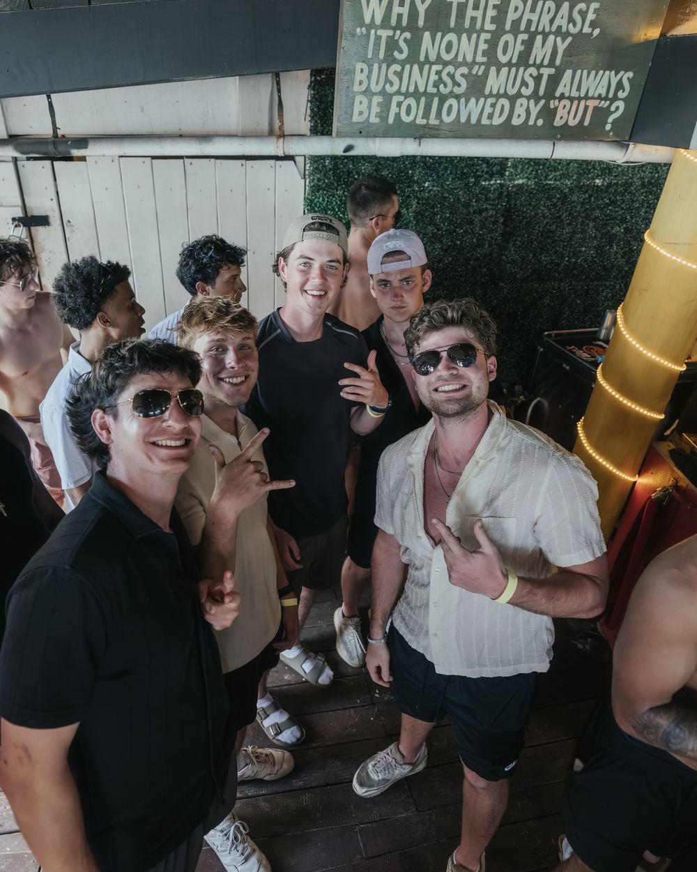 A crew of guys in sunglasses grinning at the camera at a Señor Frog's day party in Panama City Beach